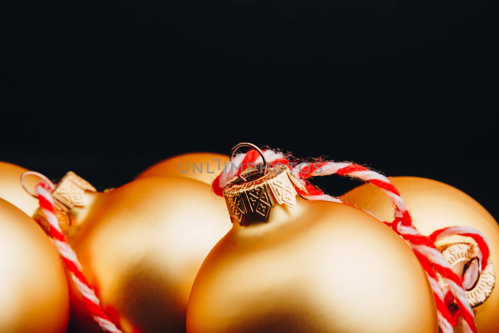 Colored christmas decorations on black wooden table. Xmas balls on wood background. Top view, copy space. new year