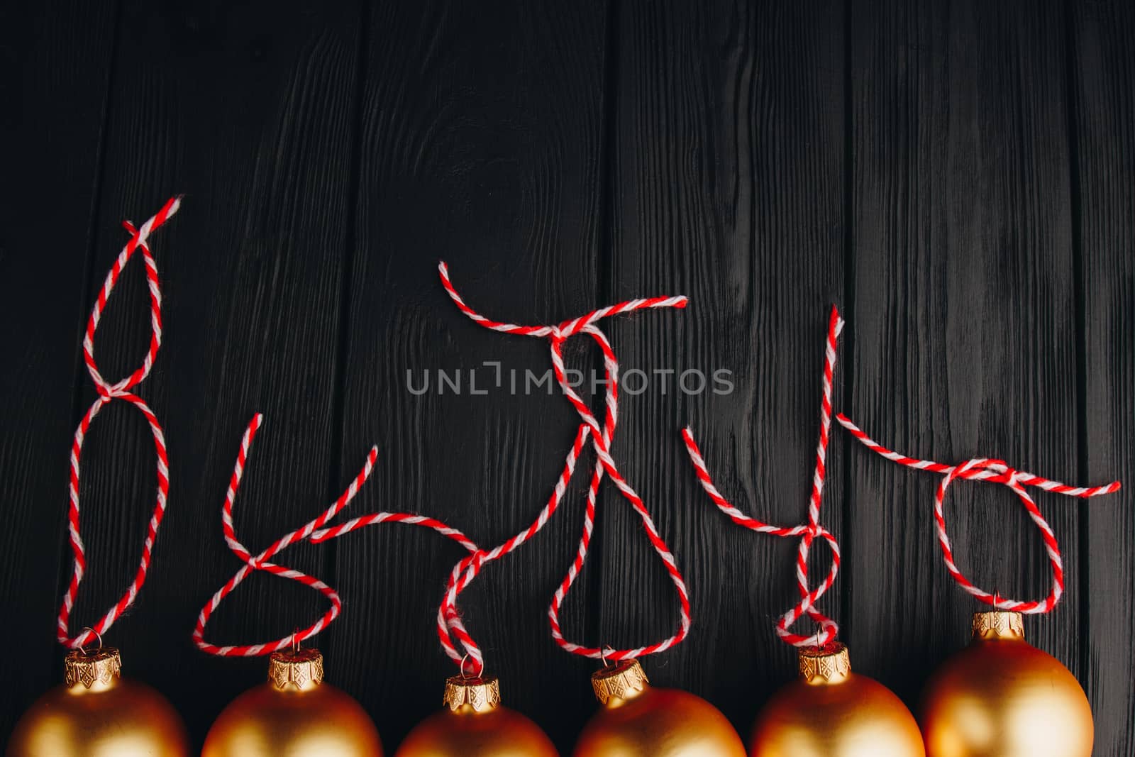 Colored christmas decorations on black wooden table. Xmas balls on wood background. Top view, copy space. new year