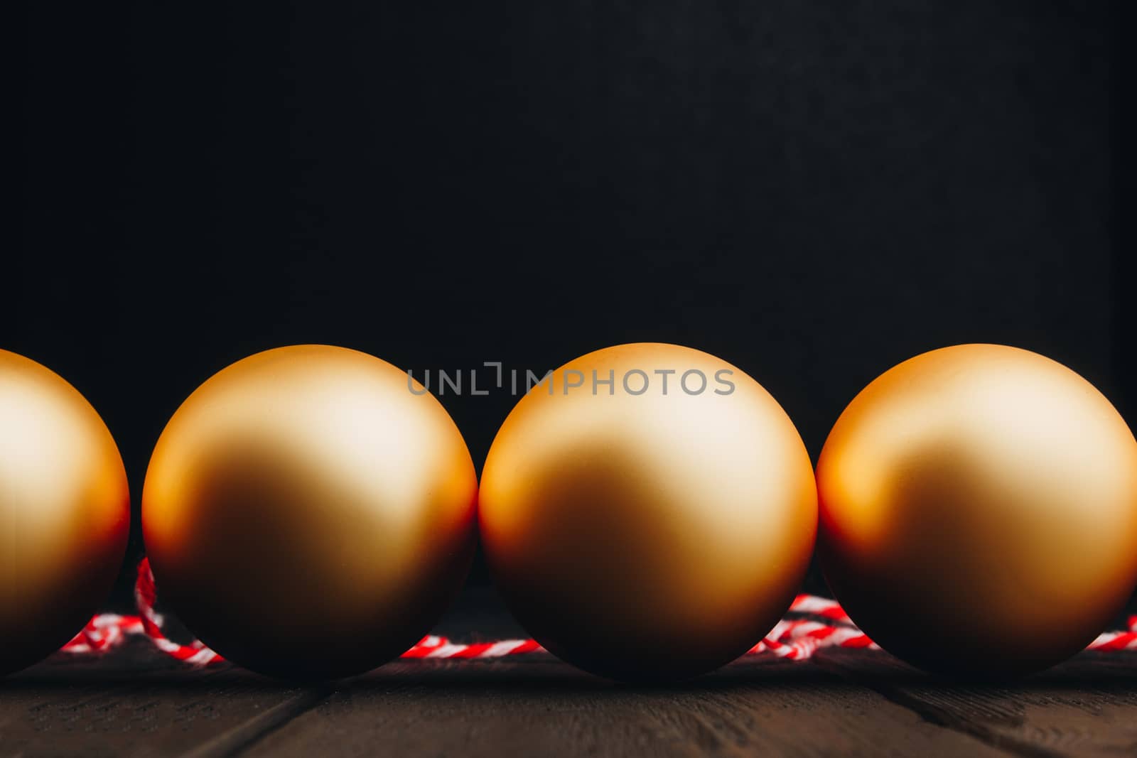 Colored christmas decorations on black wooden table. Xmas balls on wooden background. Top view, copy space. new year by yulaphotographer