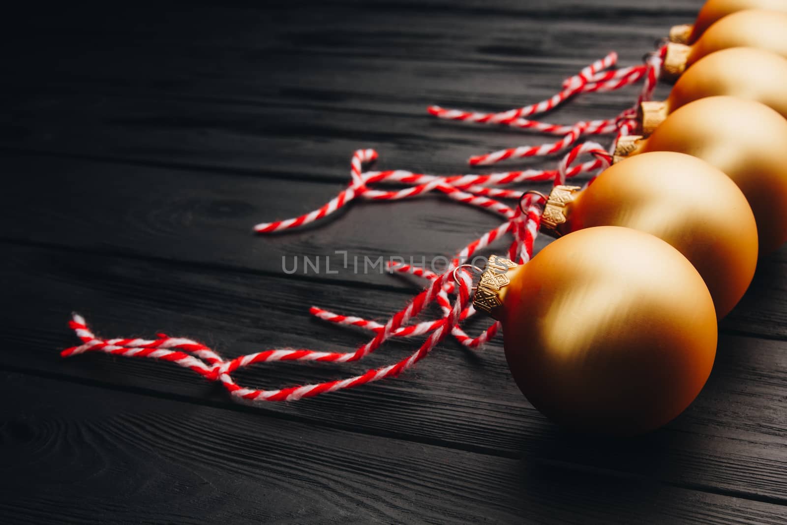 Colored christmas decorations on black wooden table. Xmas balls on wooden background. Top view, copy space. new year by yulaphotographer