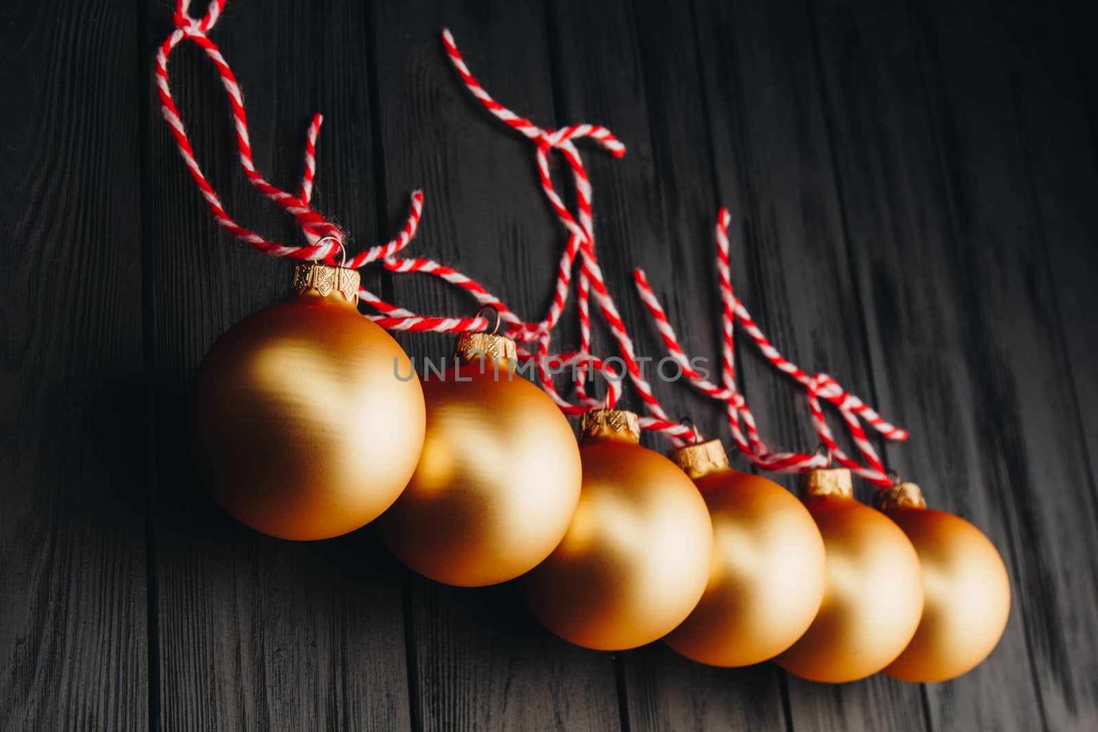 Colored christmas decorations on black wooden table. Xmas balls on wooden background. Top view, copy space. new year by yulaphotographer