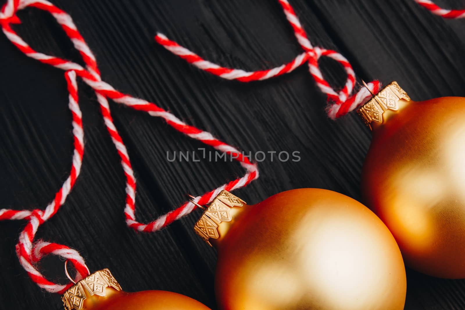 Colored christmas decorations on black wooden table. Xmas balls on wooden background. Top view, copy space. new year by yulaphotographer