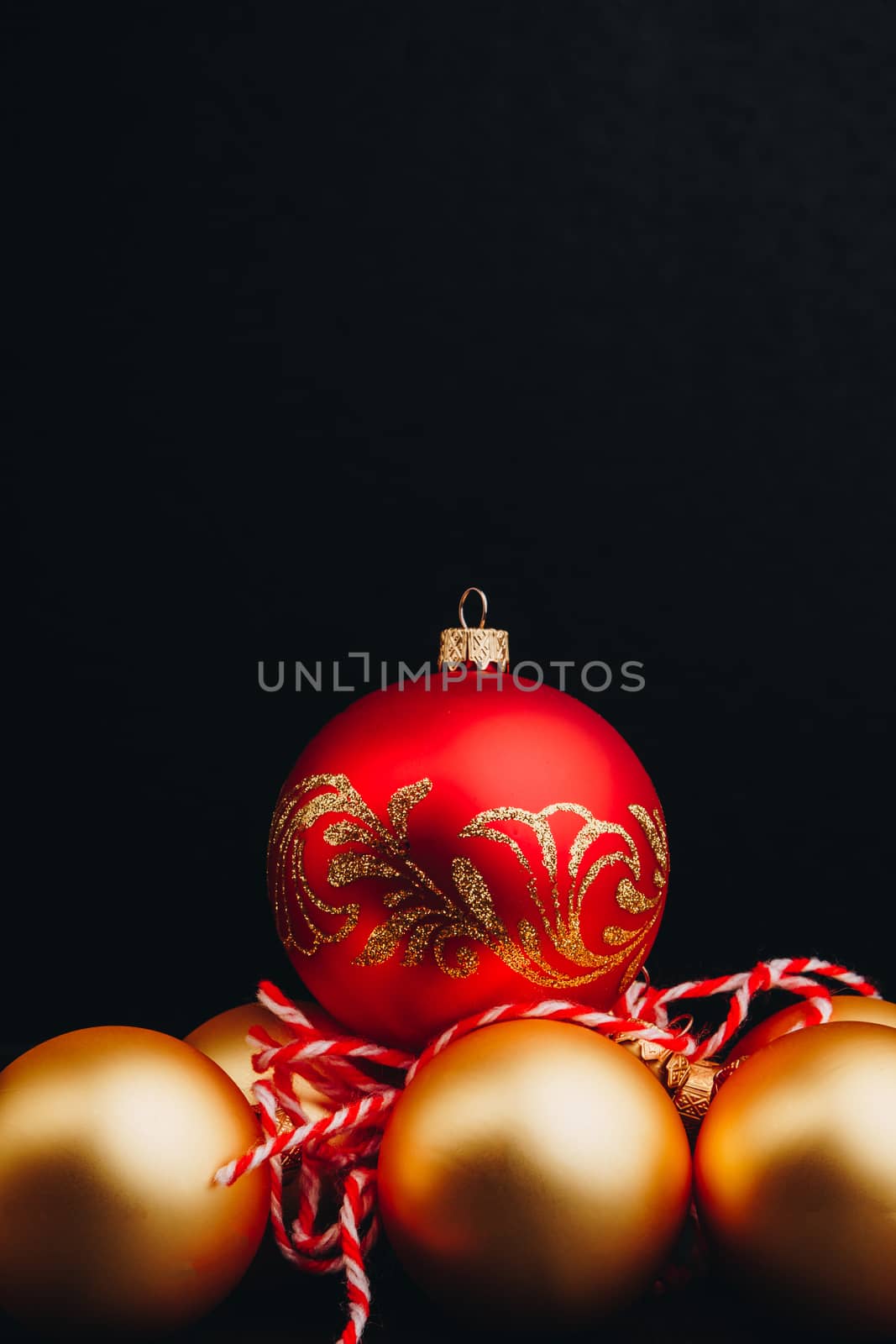 Colored christmas decorations on black wooden table. Xmas balls on wood background. Top view, copy space. new year