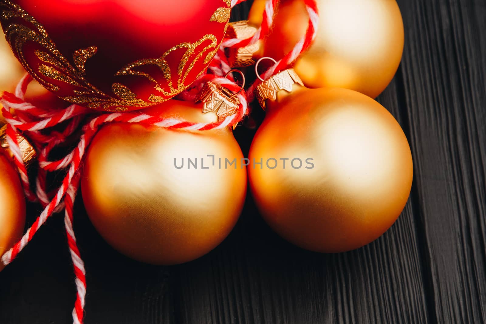 Colored christmas decorations on black wooden table. Xmas balls on wooden background. Top view, copy space. new year by yulaphotographer