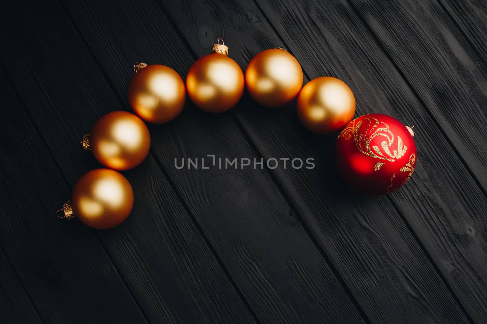 Colored christmas decorations on black wooden table. Xmas balls on wood background. Top view, copy space. new year