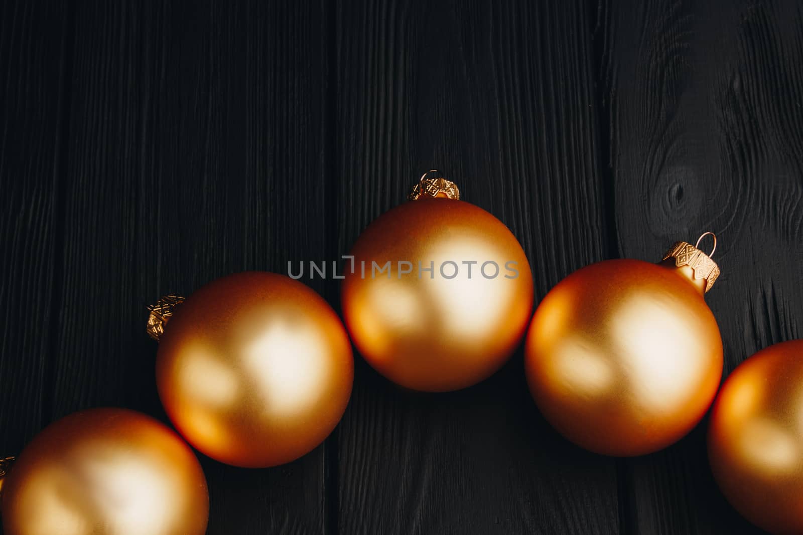 Colored christmas decorations on black wooden table. Xmas balls on wood background. Top view, copy space. new year