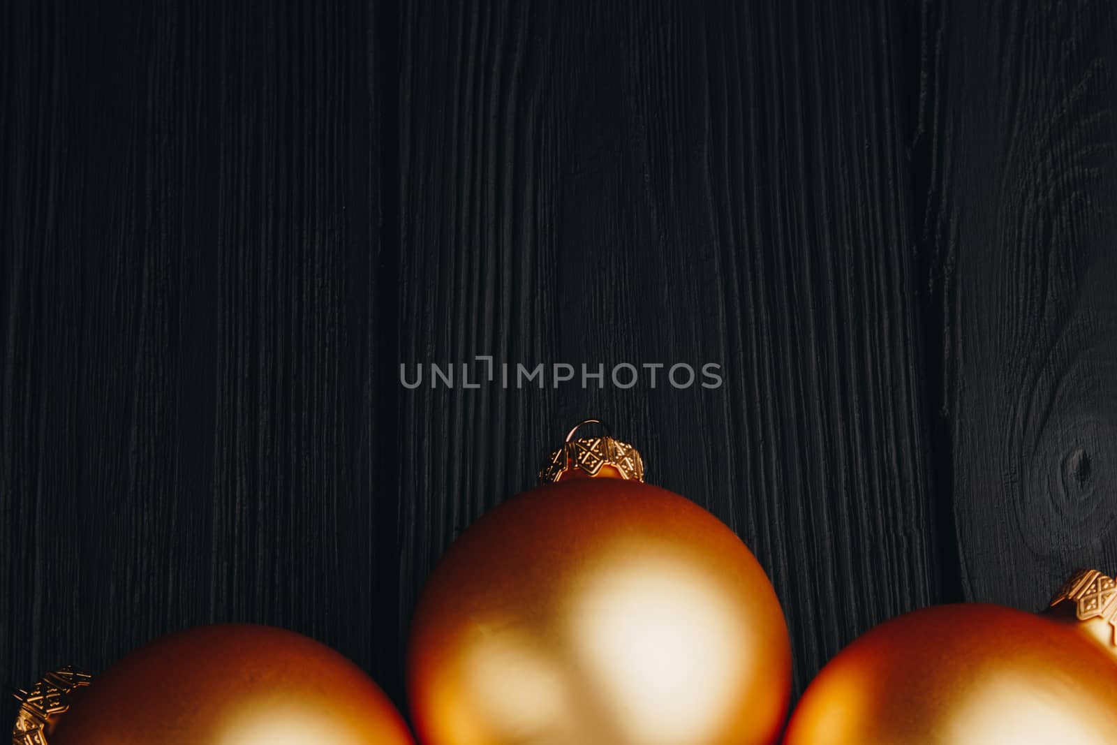 Colored christmas decorations on black wooden table. Xmas balls on wooden background. Top view, copy space. new year by yulaphotographer