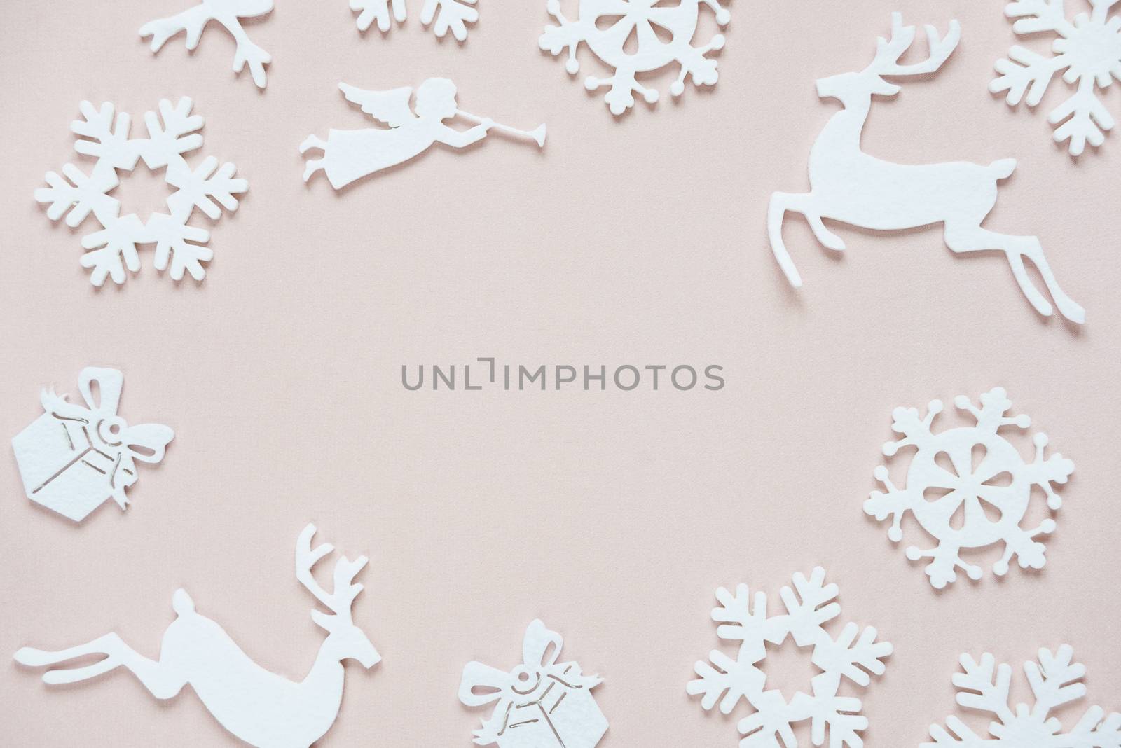 Christmas frame composed of white christmas decoration: snowflakes, deers, flying angel and gift boxes on pink background. Flat lay composition for websites, social media, business owners, magazines,  bloggers, artists etc.