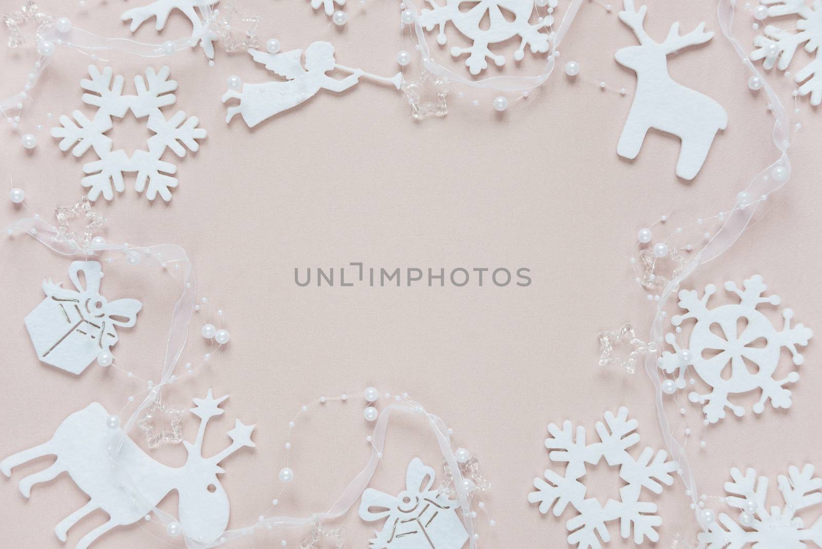 Christmas frame composed of white christmas decoration: snowflakes, deers, flying angel and gift boxes on pink background. Flat lay composition for websites, social media, business owners, magazines,  bloggers, artists etc.