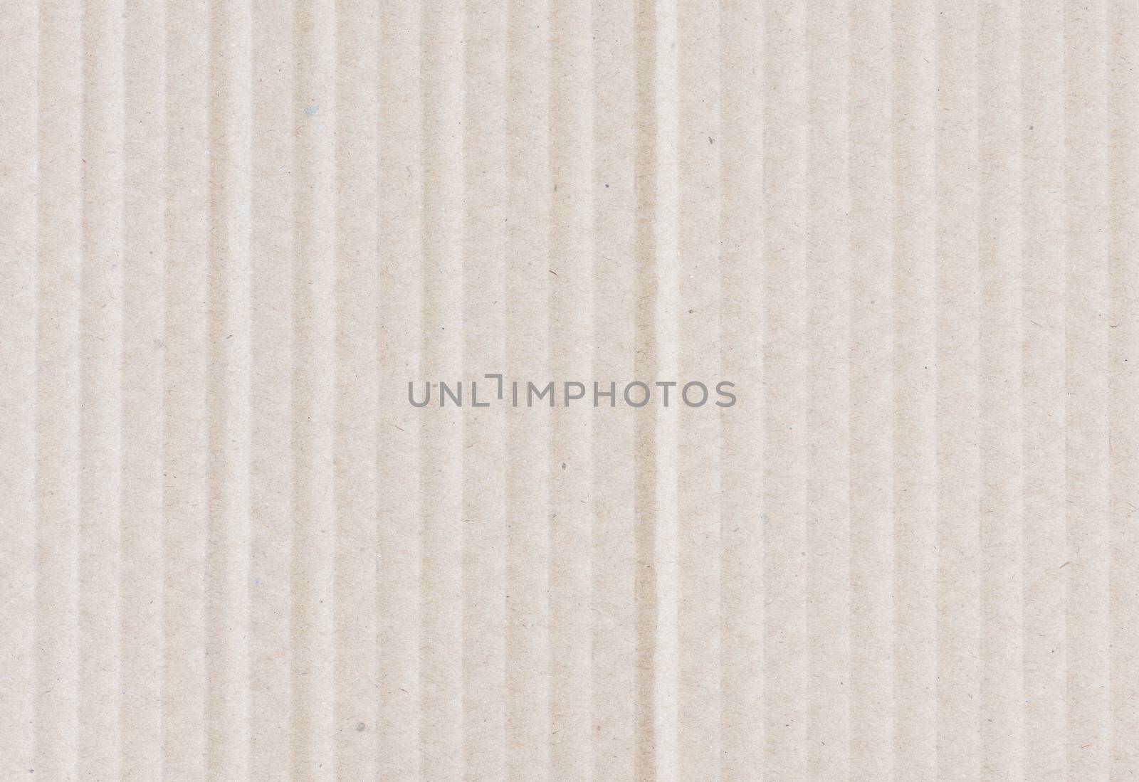 Beige background of kraft corrugated cardboard closeup