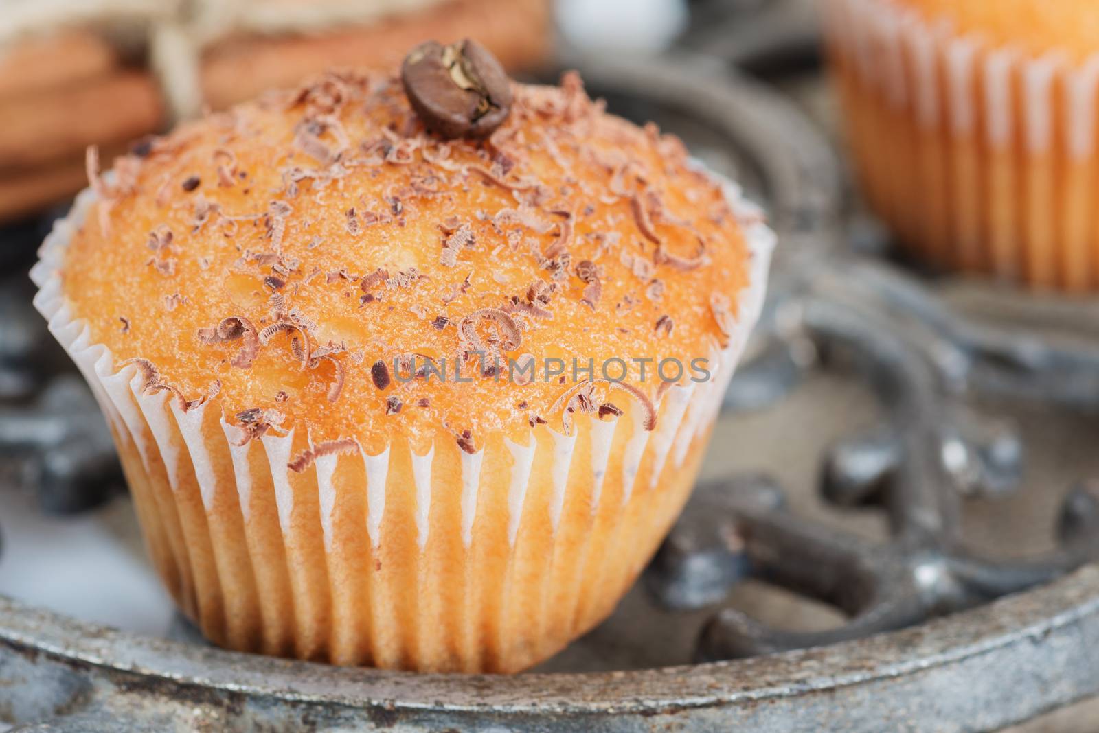 Cupcakes with chocolate shavings surrounded by coffee beans