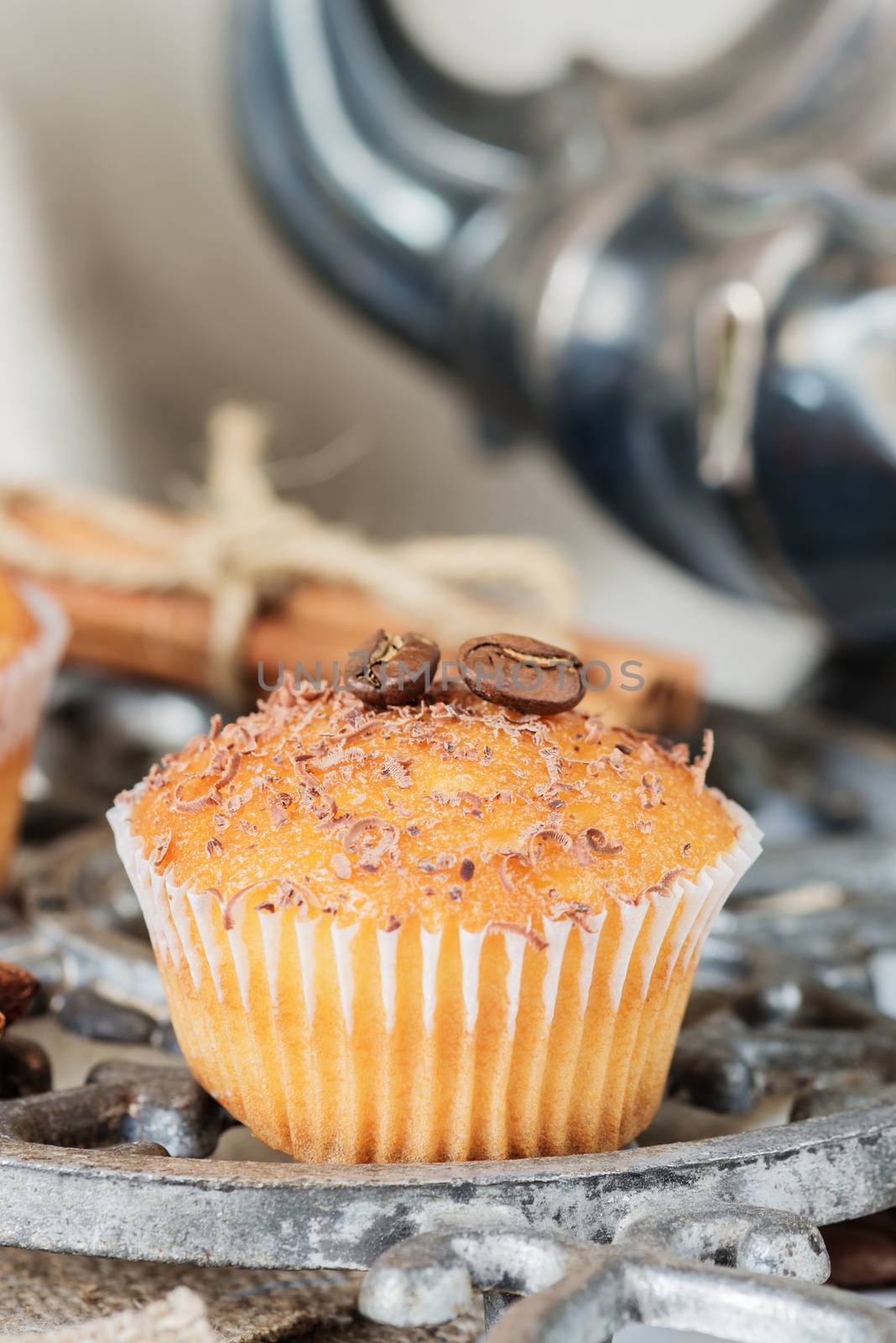 Cupcakes with chocolate shavings surrounded by coffee beans