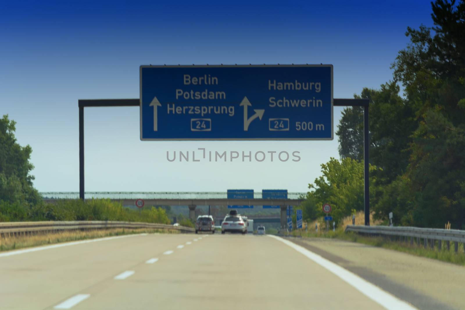 German motorway sign with inscription in German direction arrow to the cities - Berlin, Potsdam, Herzsprung, Hamburg and Schwerin