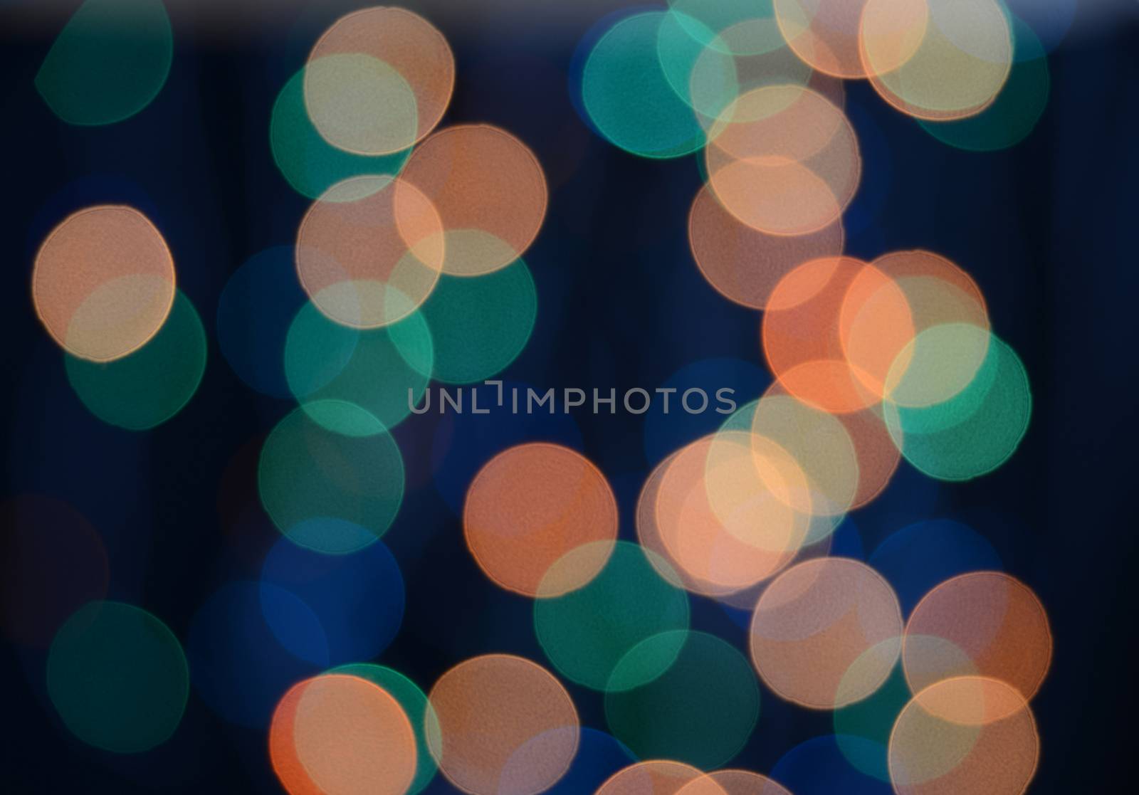 Defocused colored lights on the black background. Multicolored bokeh