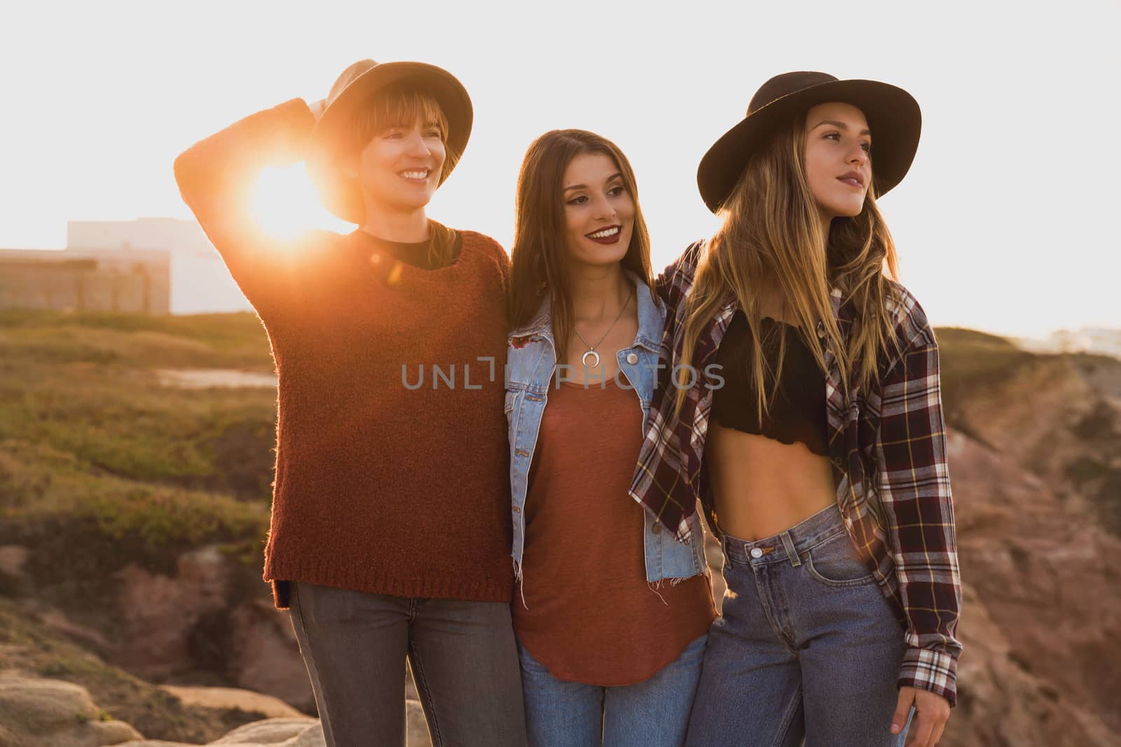 Three best friends near the coastline having a good time