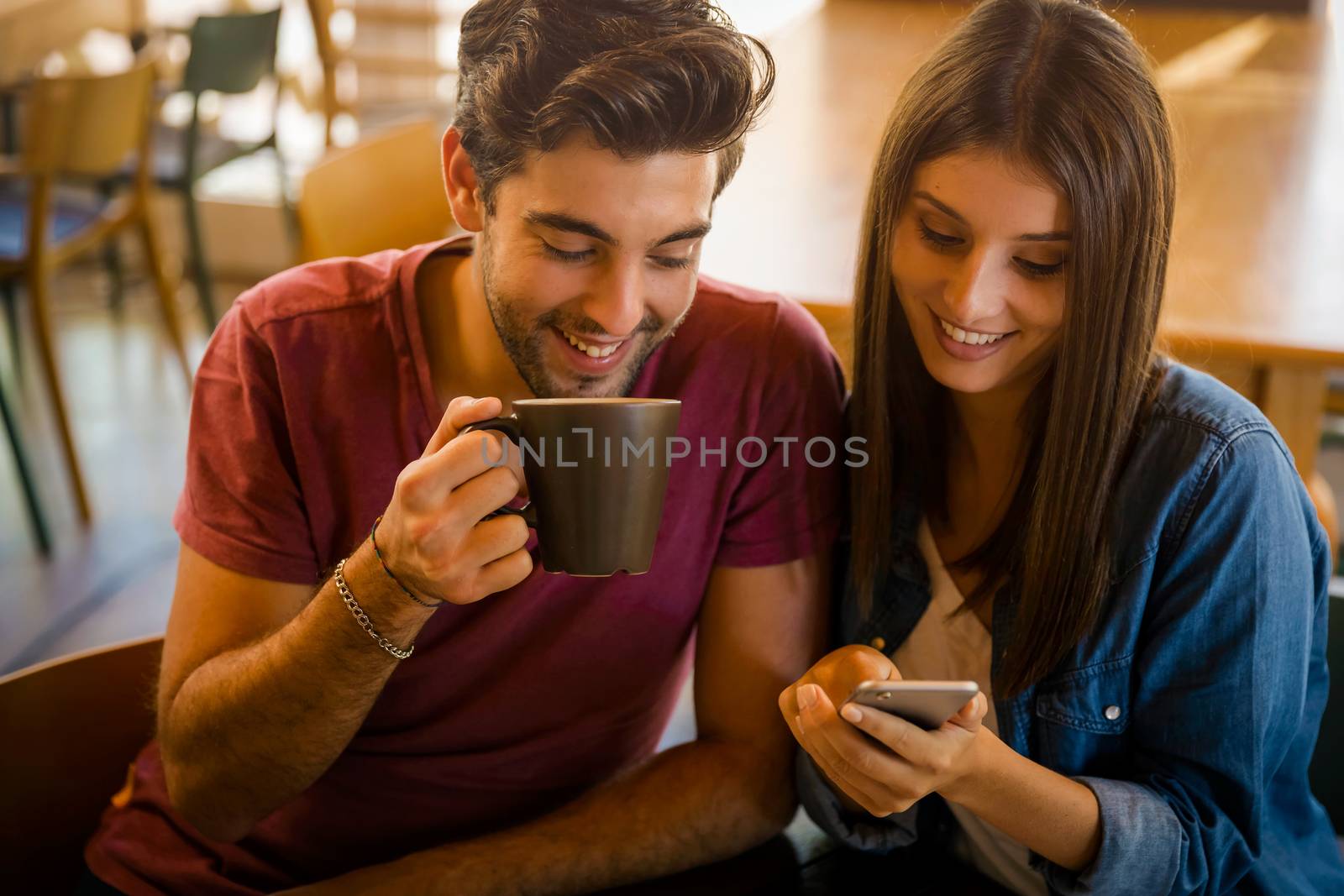 Friends studying together and watching something on the phone