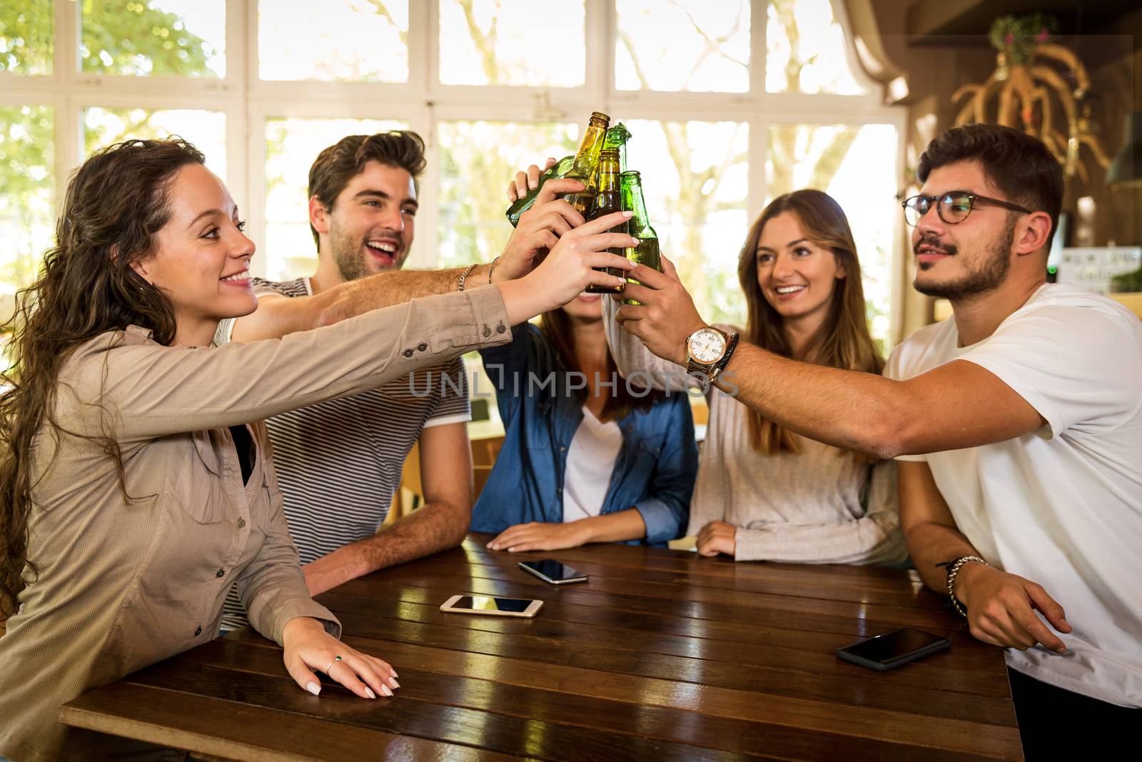 Group of friends hanging out and making a toast with beer 