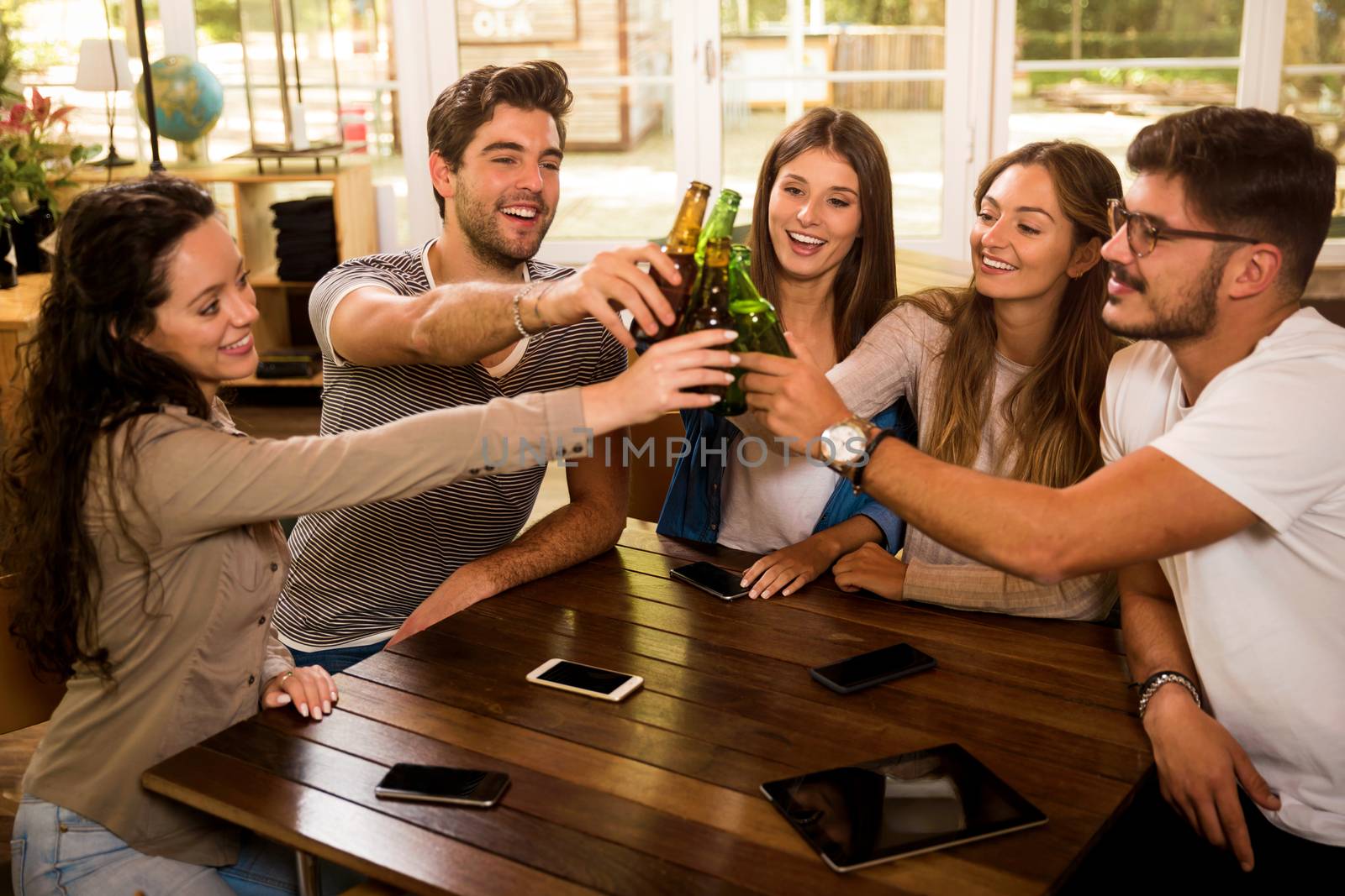 Group of friends hanging out and making a toast with beer 