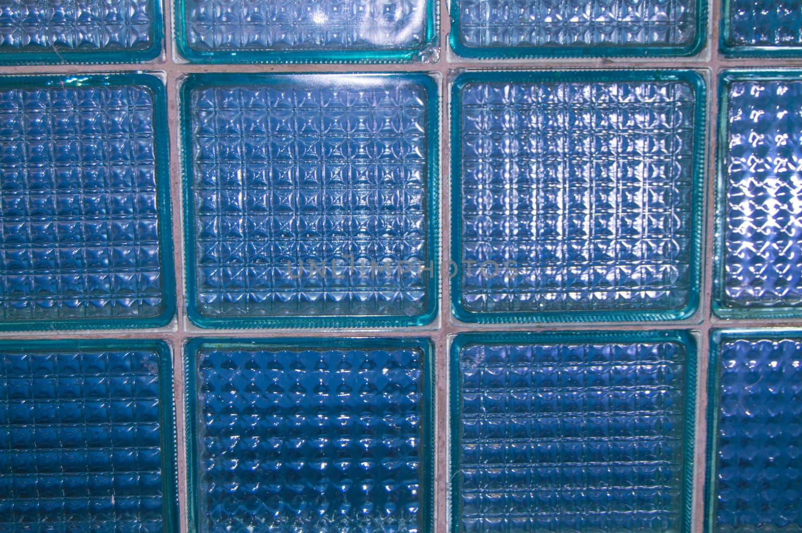 BACKGROUND TEXTURE OF GLASS TRANSPARENT SQUARE TILES.