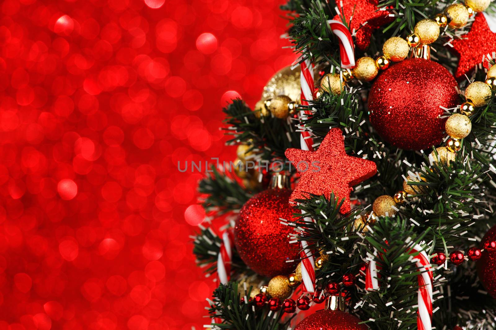 Beautiful christmas tree decorated with baubles and candies