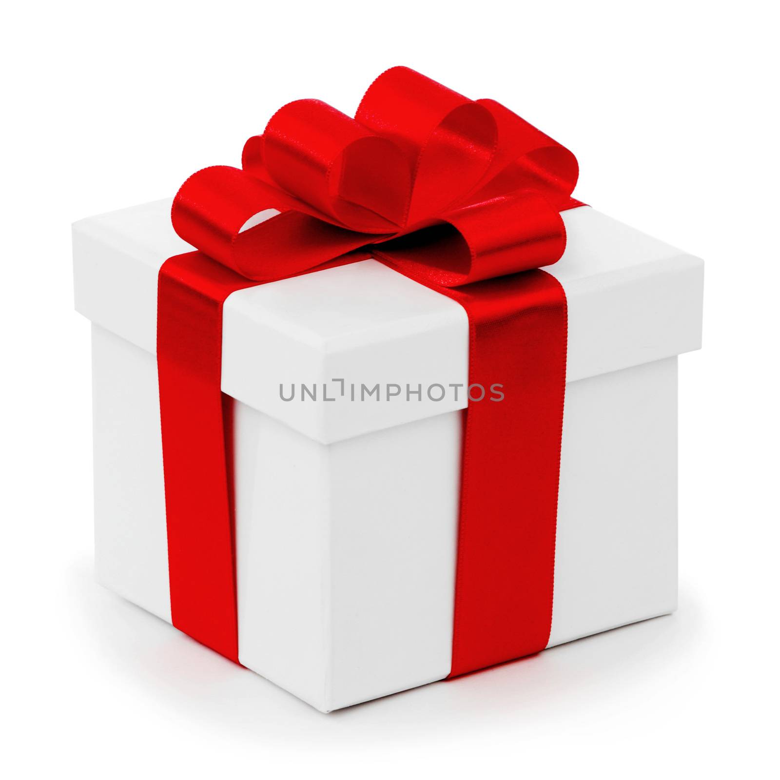 White gift box with red ribbon bow isolated on white background close-up