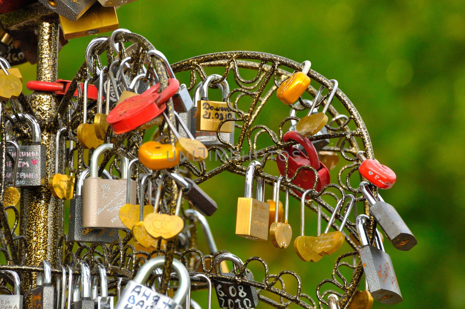 Colorful vibrant wedding love heart locks on the bridge.