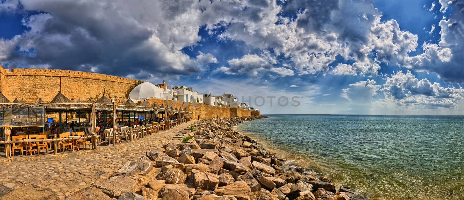 HAMMAMET, TUNISIA - OCT 2014: Cafe on stony beach of ancient Med by Eagle2308