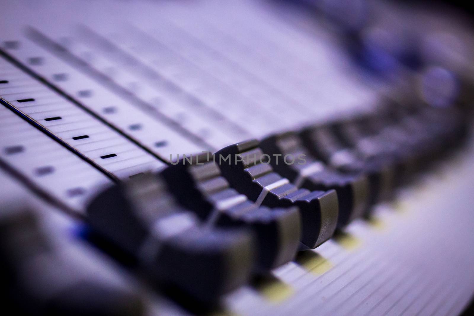 Side view of Faders on Professional Lighting Designers Programming Desk. Selective Focus Blur