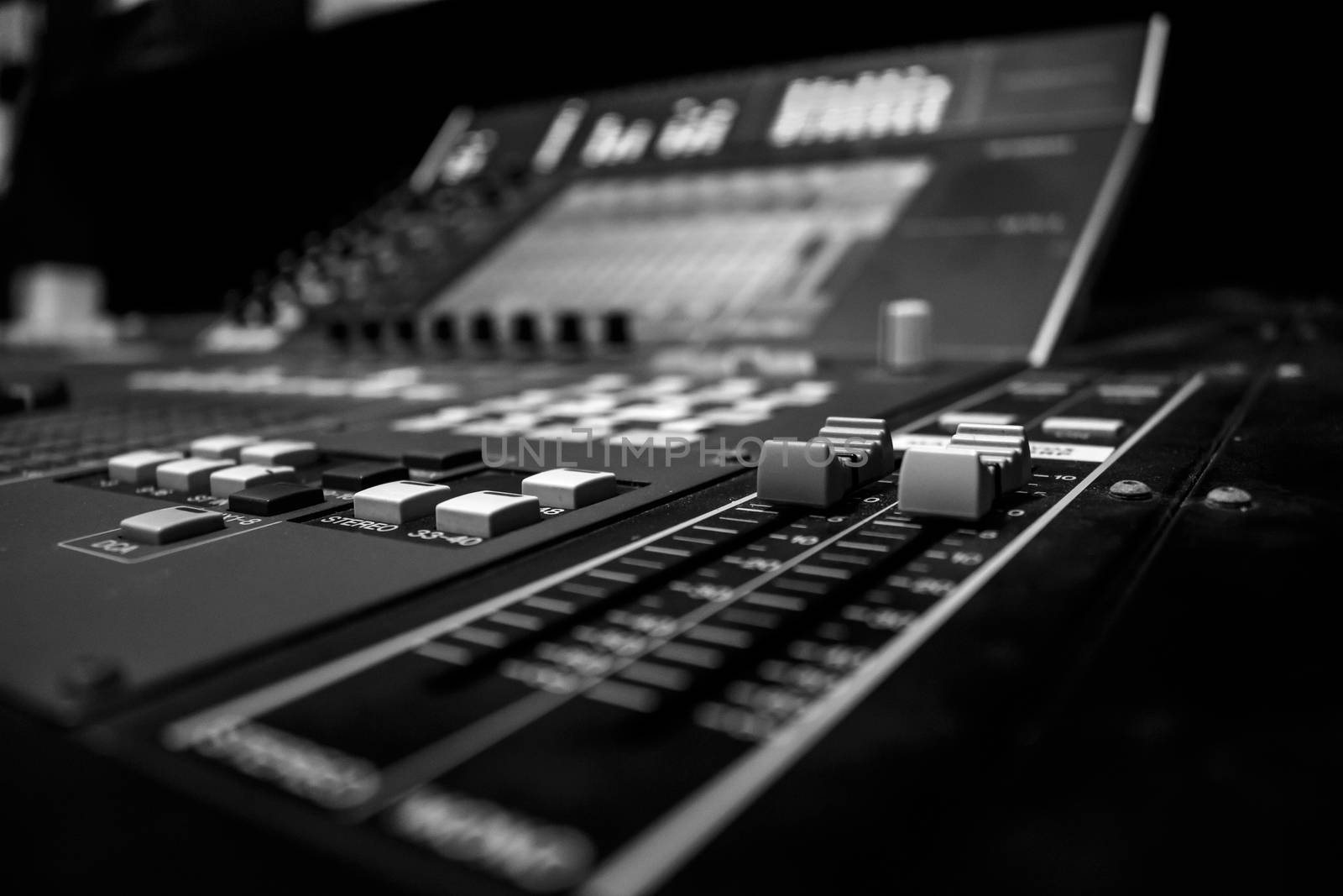 Wide angle shot of Professional Audio Mixing Console with digital control encoder, monochrome, black and white