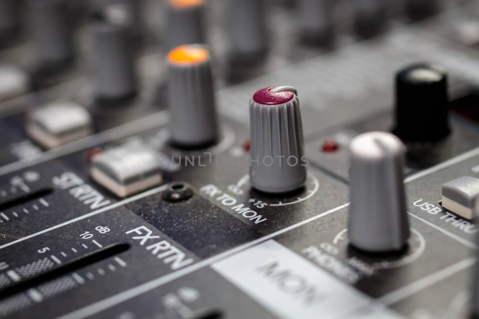 Red Audio fx send to monitor control knob on a professional sound mixing console/ desk