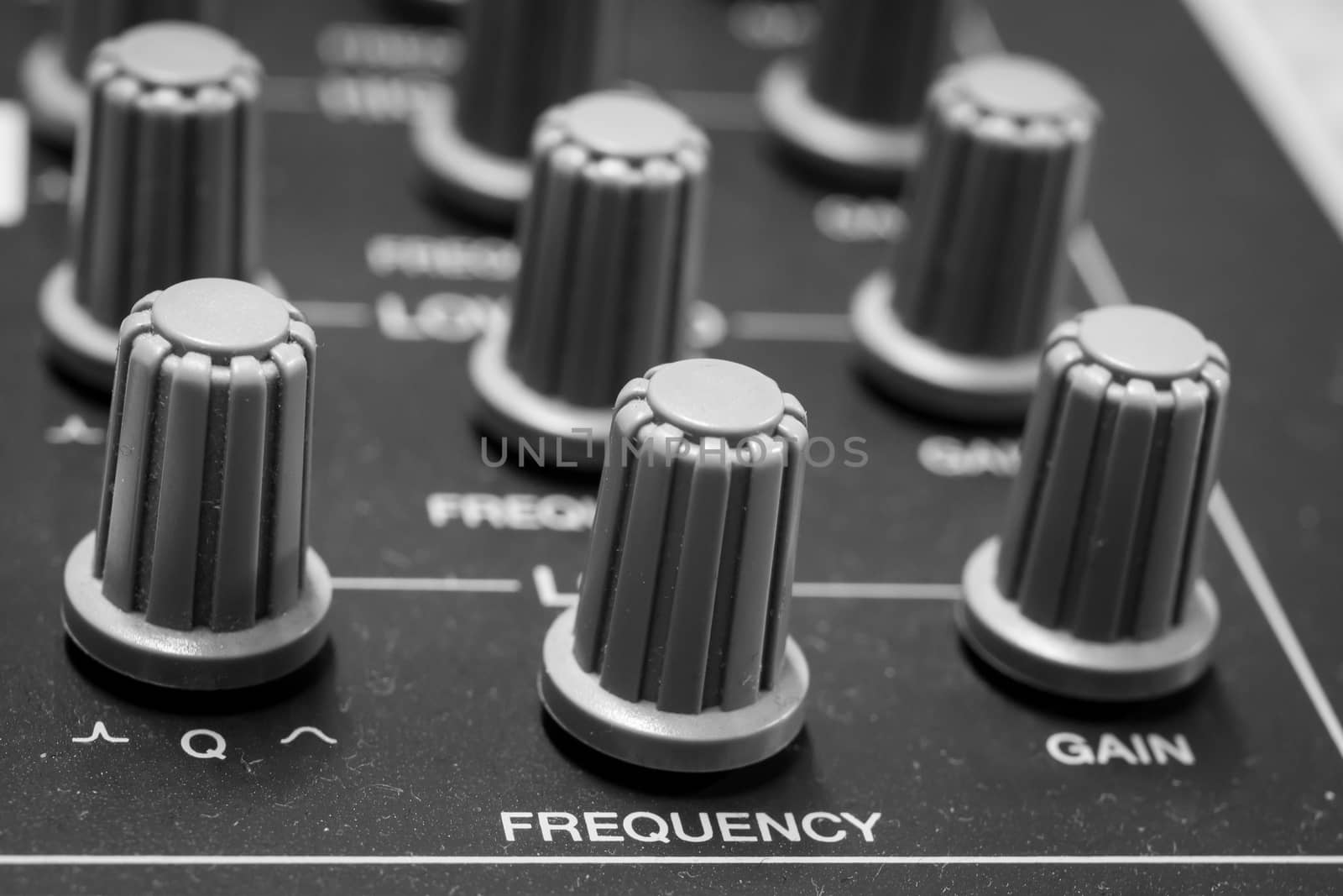 Closeup view of Faders on Professional digital Audio mixing control Console with zero decimal indicators