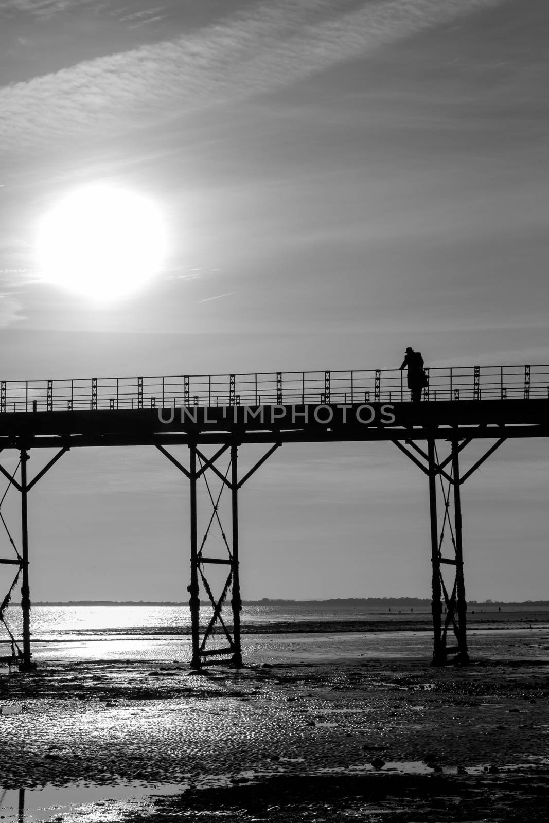 Monochrome single man thinking on an old english victorian seaside pier