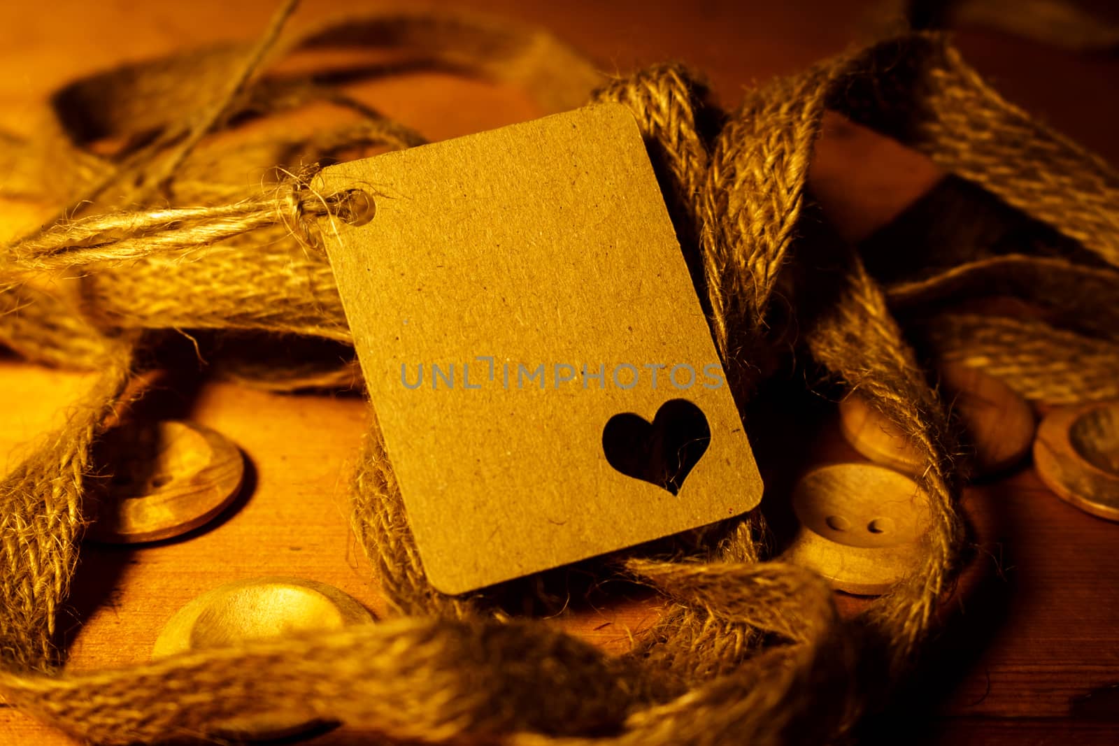 Rectangle Shaped Valentines day gift card tag on wooden background with vintage rustic twine and old buttons