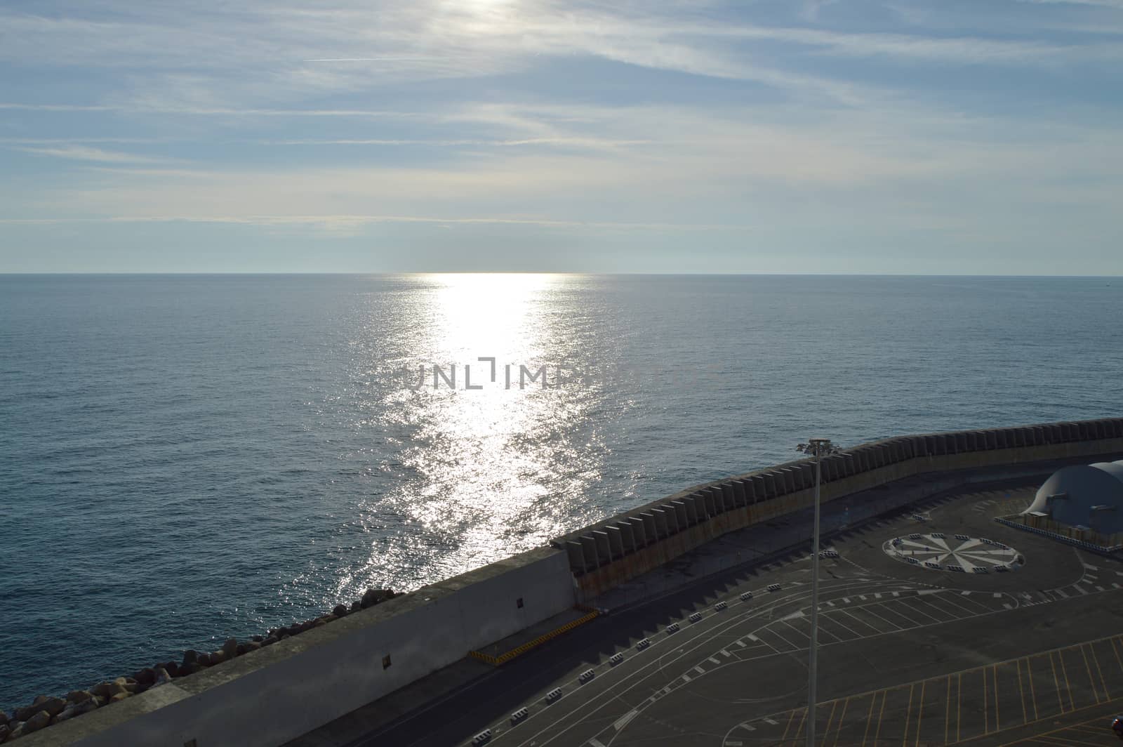 Beautiful sunset and silver path on the sea, blue clouds in the sky, background.