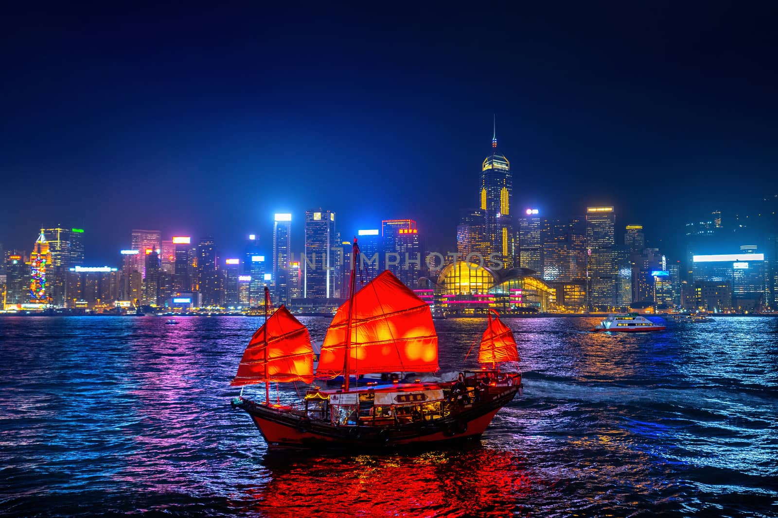 Victoria Harbour with junk ship at night in Hong Kong. by gutarphotoghaphy