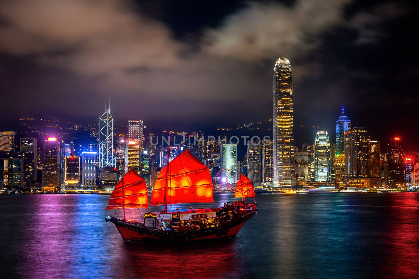Victoria Harbour with junk ship at night in Hong Kong. by gutarphotoghaphy