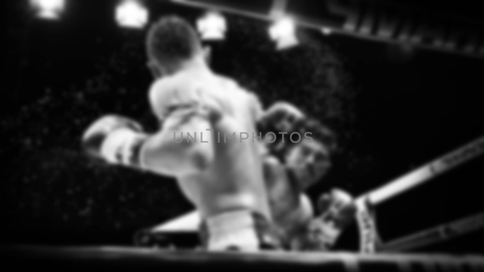 Blurred images black and white photo style of Thai boxing or Muay Thai or Kickboxing which local and foriegn boxer are fighting on the ring at indoor stadium stage as a martial art sport competition for traveller sightseeing