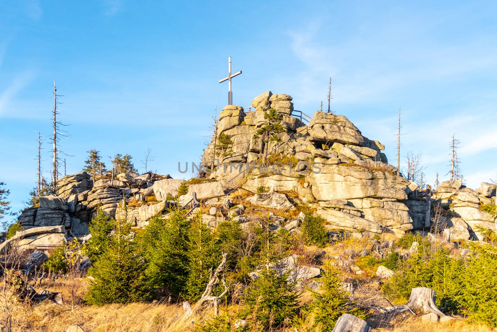 Granite rock formation with wooden cross on the top of Hochstein near Dreisesselberg, Tristolicnik. Border between Bayerische Wald in Germany and Sumava National Park in Czech Republic.