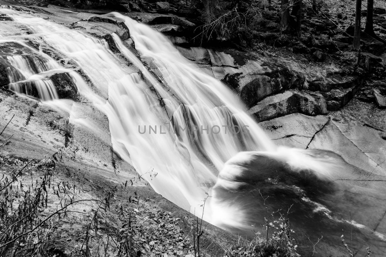 Mumlava waterfall in autumn, Harrachov, Giant Mountains, Krkonose National Park, Czech Republic. Black and white image.