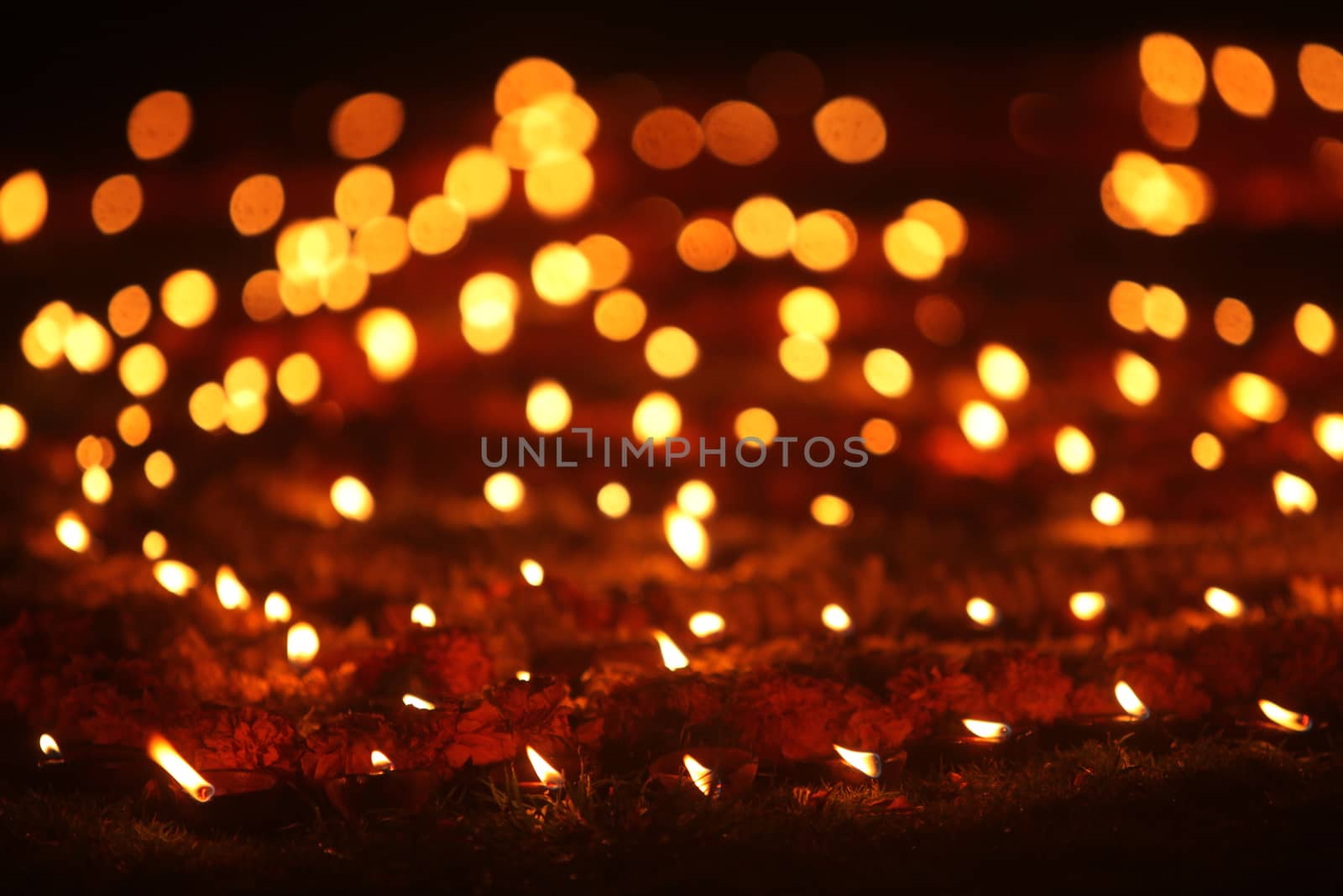 Beautiful earthen traditional lamps put in a garden lawn during Diwali festival celebration, in India.