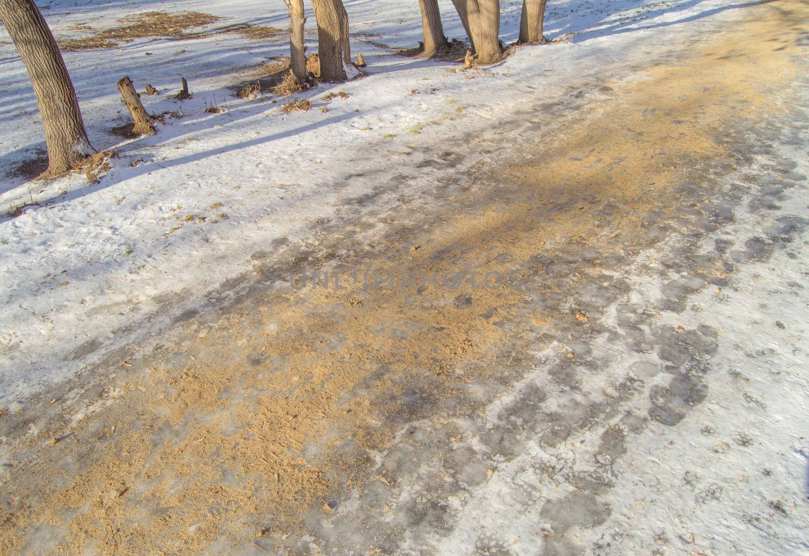 The road in the Park is covered with sand, the fight against ice and the danger of injury on a slippery road.