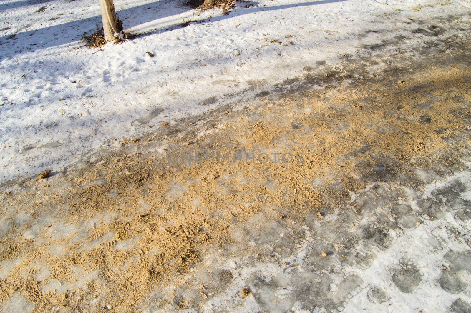 The road in the Park is covered with sand, the fight against ice and the danger of injury on a slippery road.