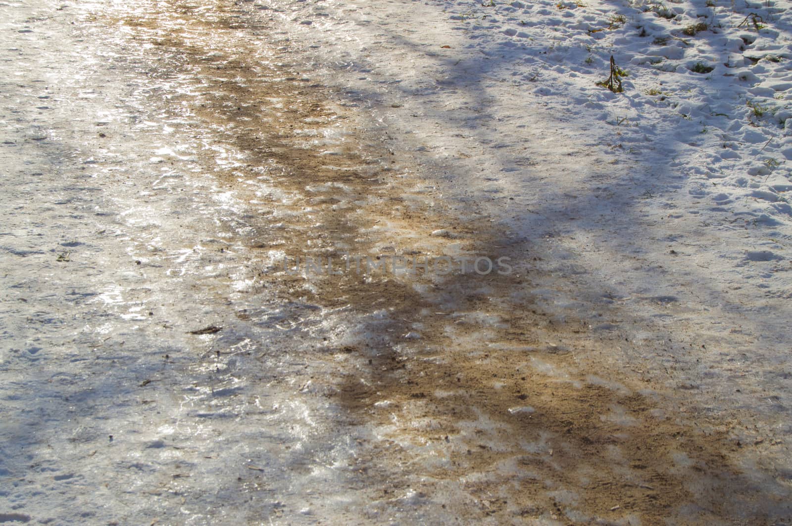 Ice track, sanded, removes ice slippery road close up.