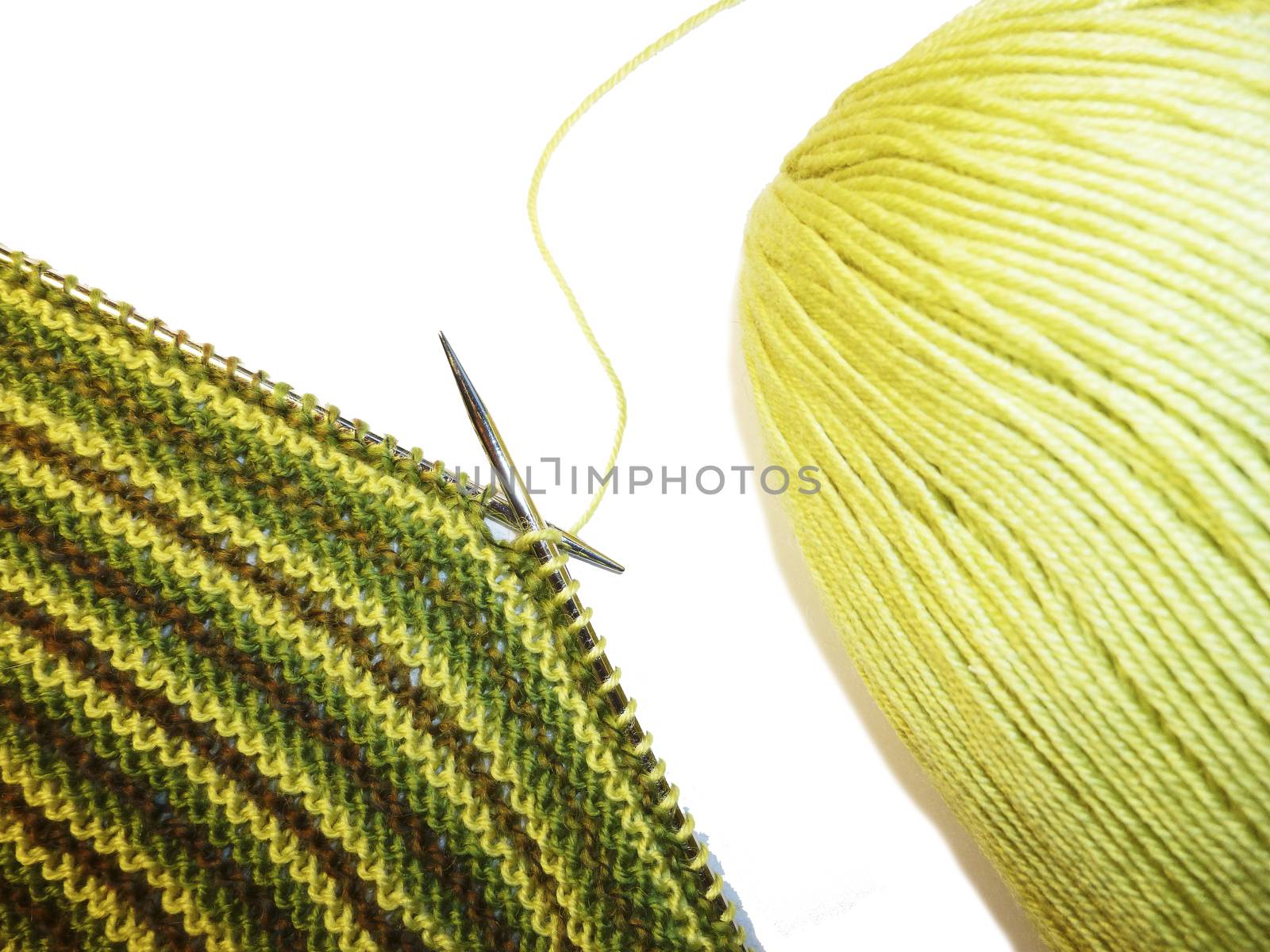 Knitting. Knitted fabric and knitting needles. Work process. Hobbies, crafts. by Julia_Faranchuk