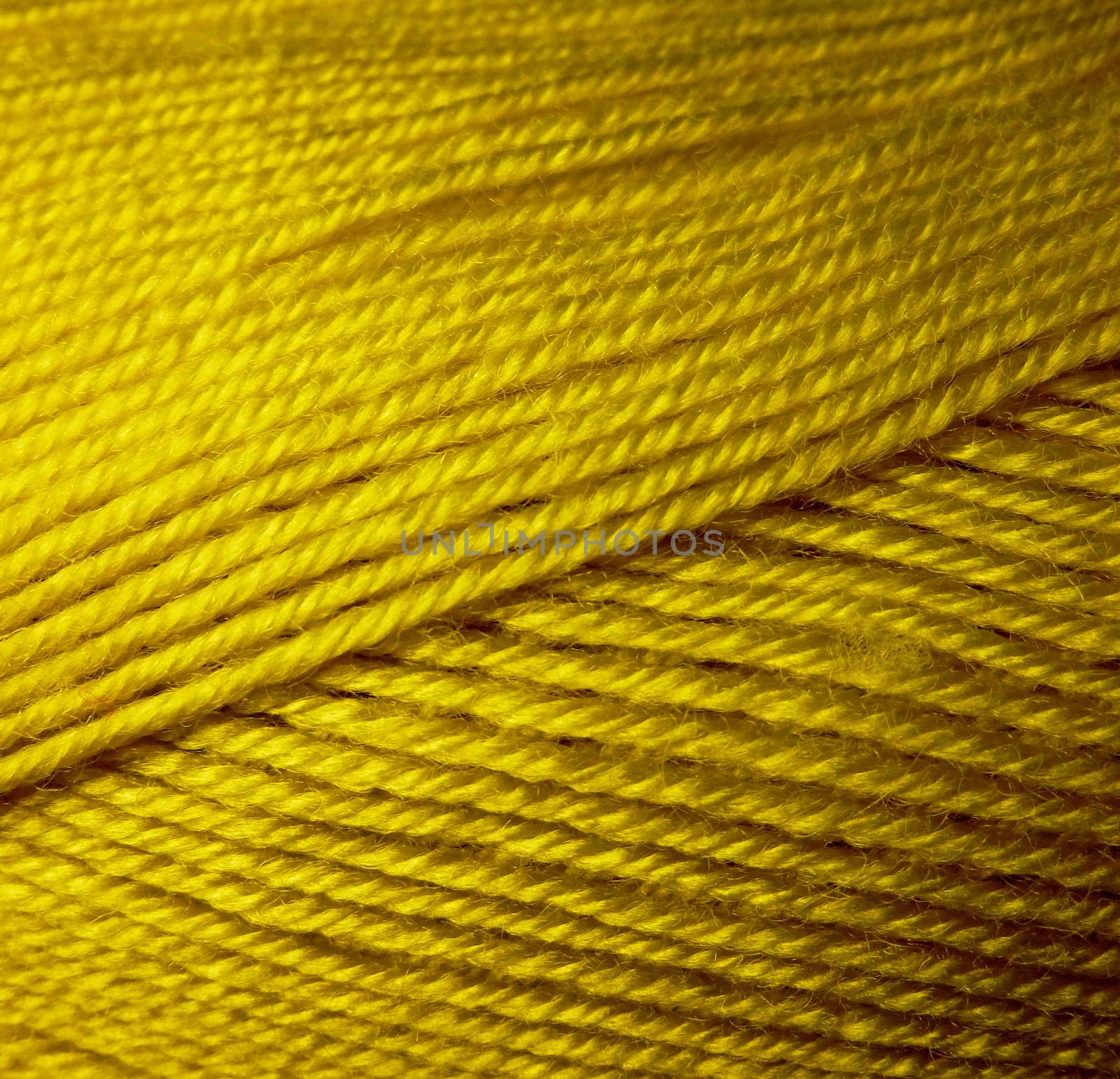 Skein of wool yarn. Macro shooting. Texture of wavy thread. Yellow green threads. Background image. Hobbies leisure crafts