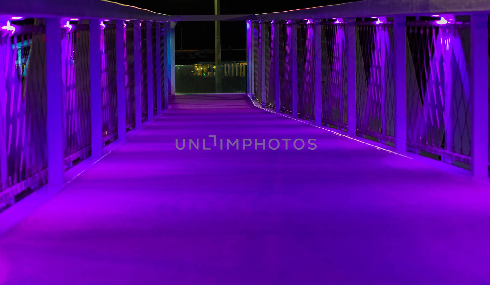 neon purple lighted bridge walking road modern architecture in scheveningen a popular city in the netherlands by charlottebleijenberg