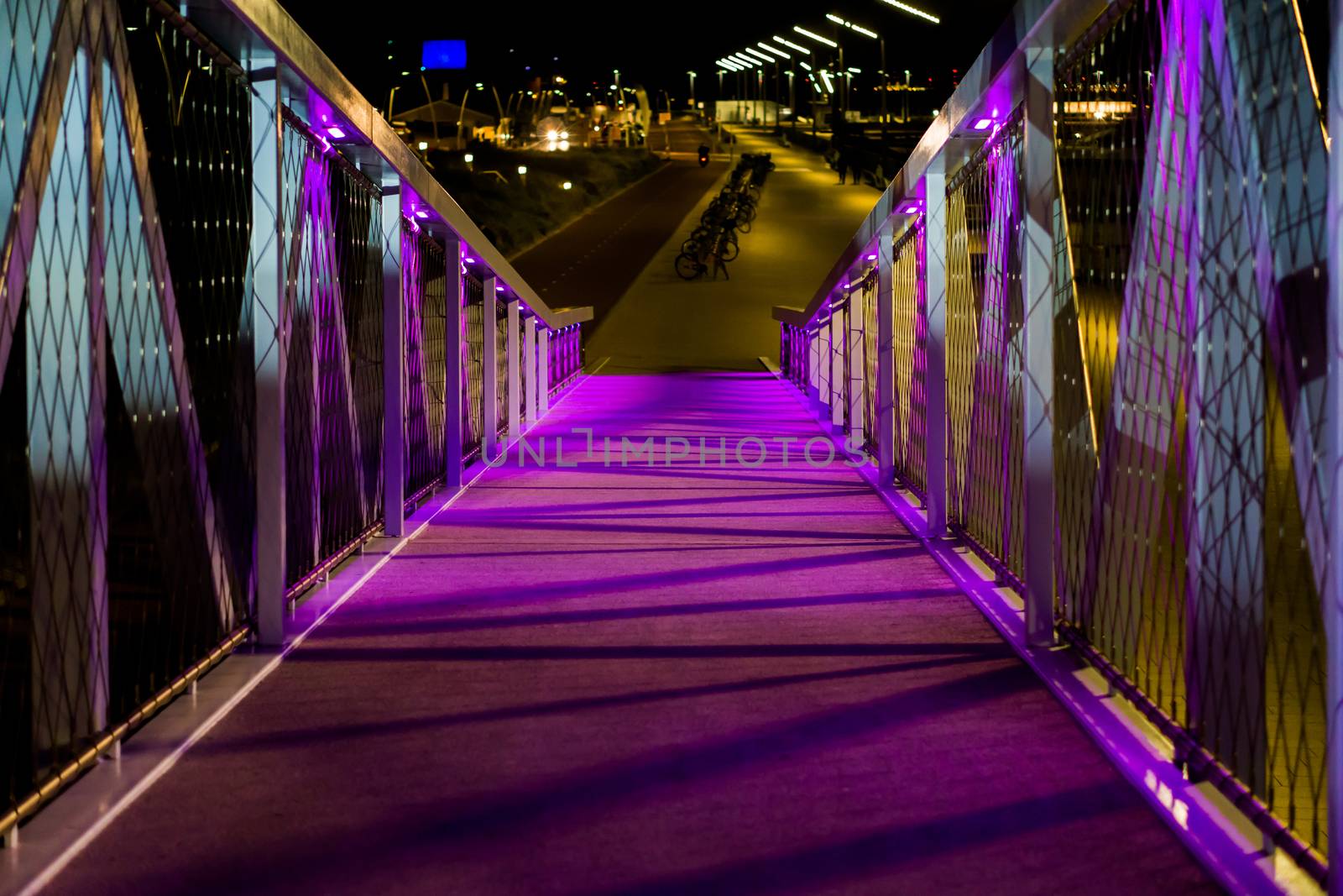 beautiful walking bridge with purple lights urban cityscape in scheveningen the netherlands