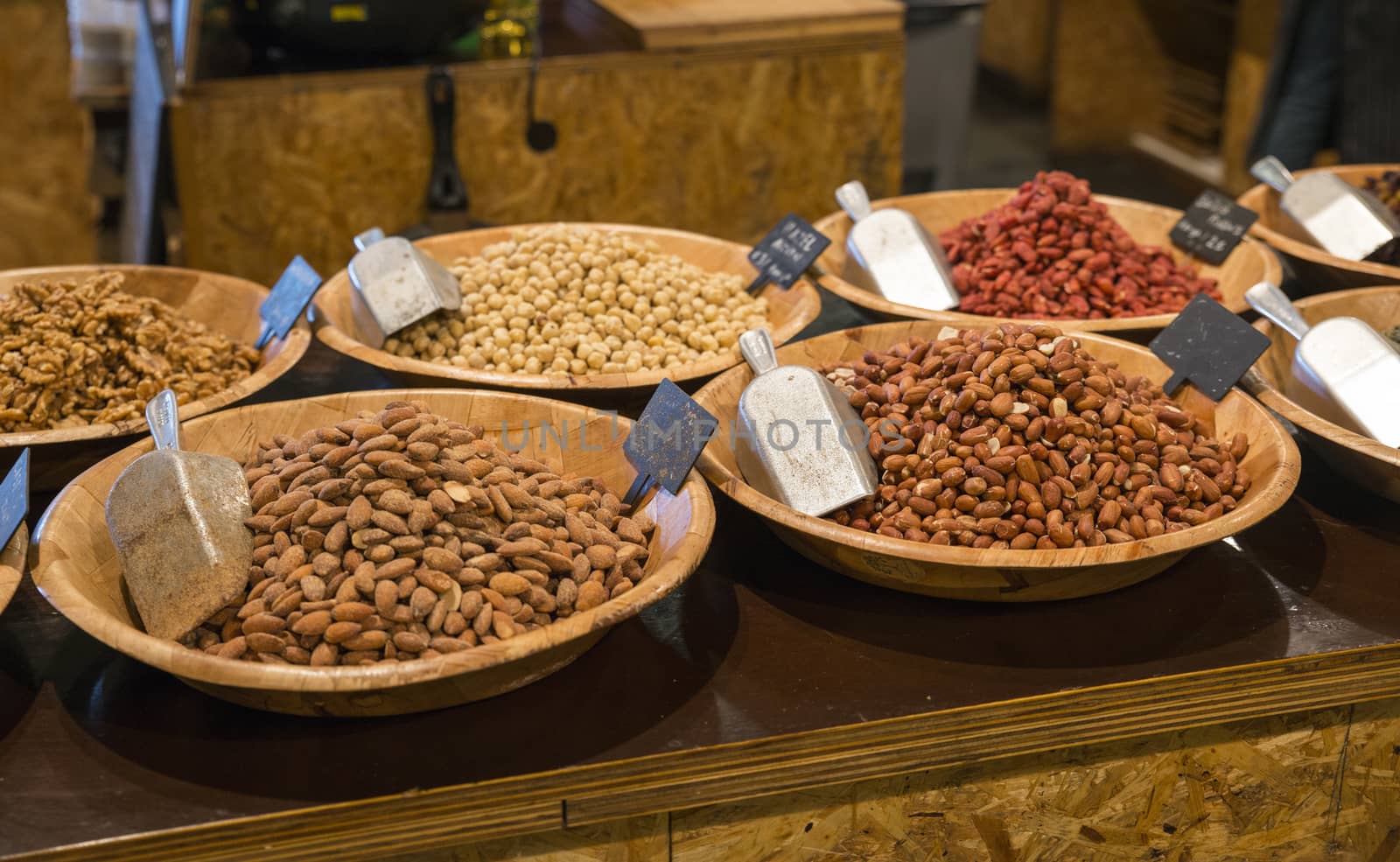 desk in a shop with peanuts walnuts hazelnuts and other nuts for selling and consumption