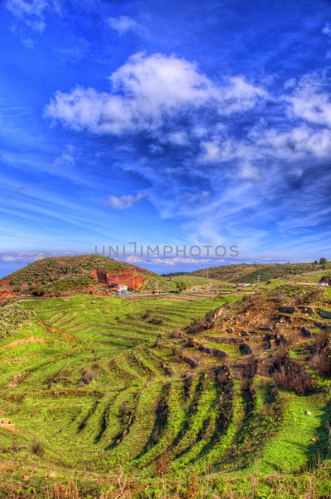 North-west coast of Tenerife mountains and green grass with blue sky with clouds, Canarian Islands.