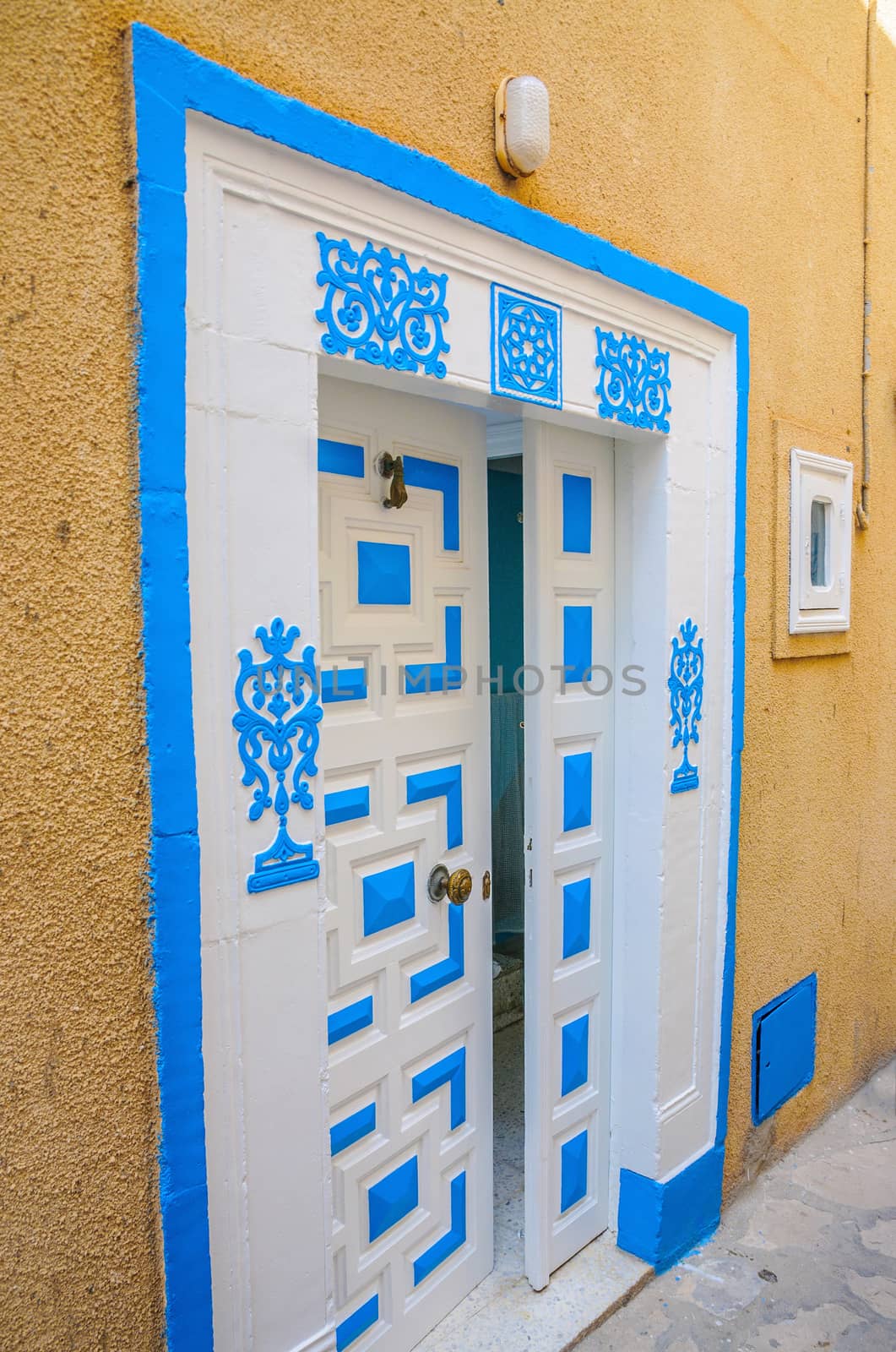 Oriental white blue door with ornament in Hammamet Tunisia by Eagle2308